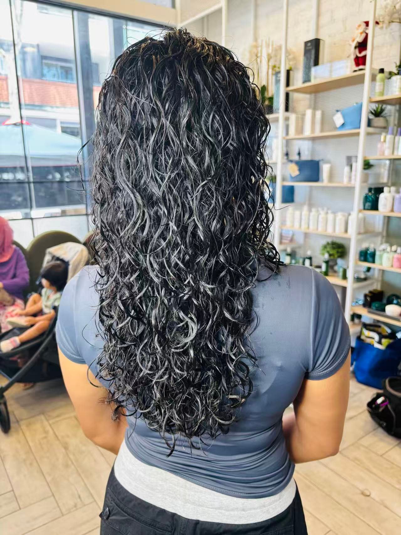 Long dark curly perm by Didi at Hair Talks Rouse Hill